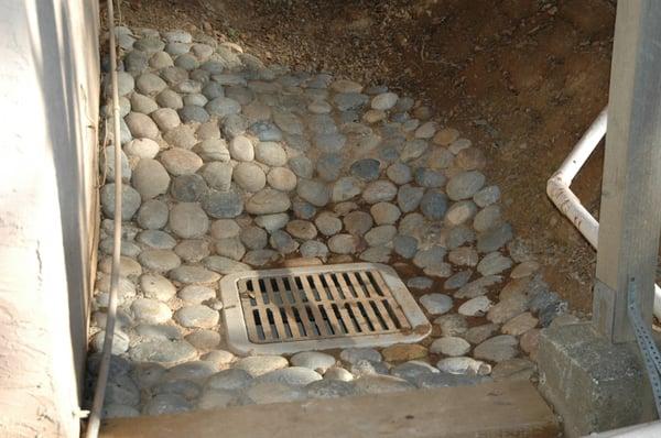 Storm drain collects rain runoff coming from two large hillsides on the side of the house.