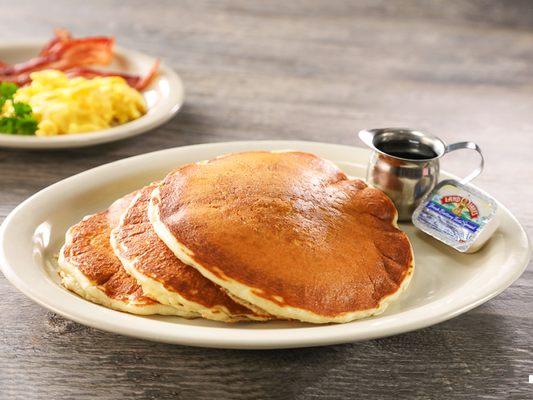 Jim's Famous Buttermilk Pancakes - Full stack of three pancakes, available with various toppings.