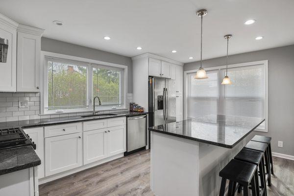 Kitchen remodel. White shaker cabinets. White subway tile backsplash. Granite countertop. Large island with seating. Philadelphia, PA.