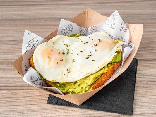 Avocado toast with two fried eggs