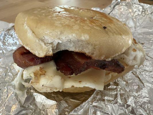 Delicious egg bacon and cheese on a plain bagel