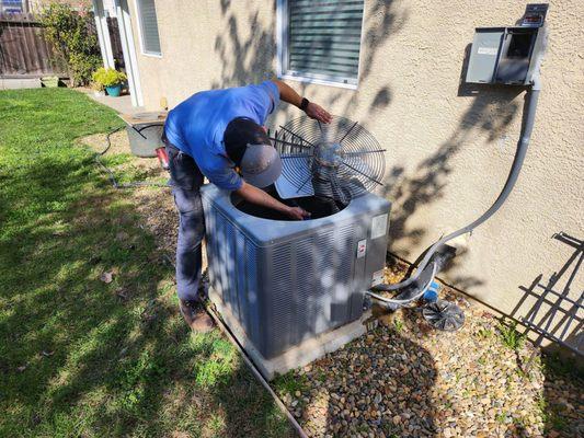 man repairing outdoor hvac unit