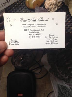 Business card with phone numbers and business hours.