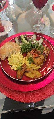 Creole Mahi-Mahi over yellow grits, plantain, eggs, croissant and salad.