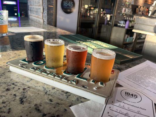 A flight including Autumn Brown Ale,3 Daughters -Pale Ale, Shiner- October Fest & Cigar City- Jai Alai-IPA