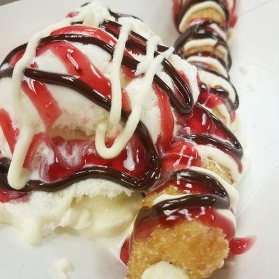 Cream cheese topped with strawberry, hot fudge, and ice cream.