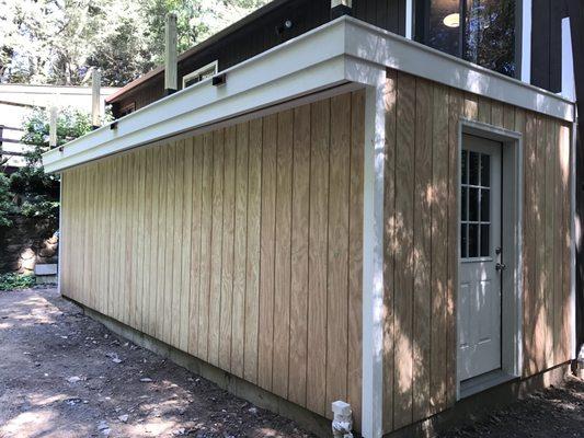 Baybrook work: Garage addition with flat roof patio/deck on top.