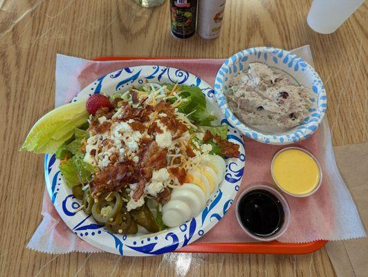 Very fresh salad with real bacon, boiled egg, candied walnuts, and a strawberry on the side. Upper right, delicious chicken salad.