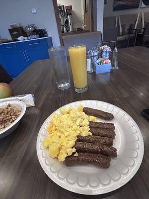 Scrambled eggs, sausage and orange juice