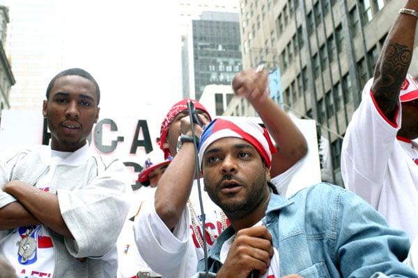 Half Puerto Rican hip hop artist Jim Jones with the bandana and behind him is rapper Juelz Santana