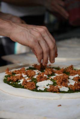 Making a Pesto Royale:

- Local basil pesto
- Cashew not-goat cheese 
 - Seitan & bulgar wheat sausage
 - Marinated bell peppers