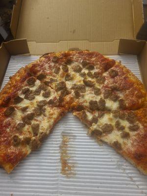 Large sausage pizza sans two slices