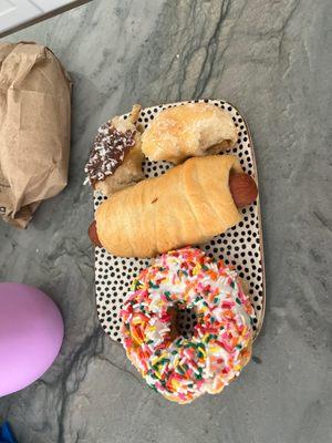 Cheese Kolache, glazed donut, sprinkle and a coconut donut.