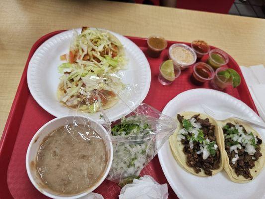 Fried fish tacos, beans, Cilantro onions, and carne asada  tacos the red one is extremely hot and good