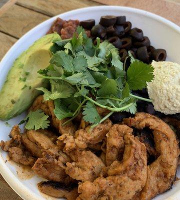 Vegan Mighty Bowl. Brown rice, lemon curry sauce (mighty sauce), chipotle soy curls, cilantro, black olives, salsa, avocado & cashew cream.