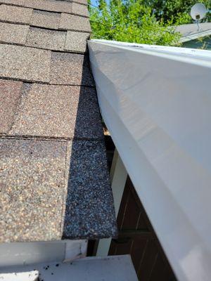 Awning not same size as old awning, awning leaning against garage and shingles were all ruffled up.