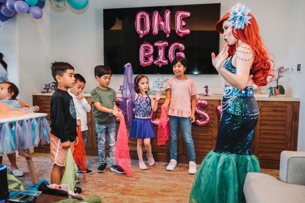 Ariel teaching kids how to swim under the sea