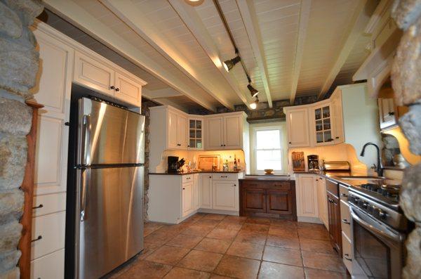 Dropping the height on the cabinet below the rear window and the custom window jamb hutch sides give this kitchen a true farm house country