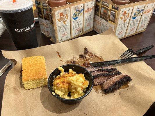 Lean brisket, Mac-n-cheese, cornbread, and a trademark Dr. Pepper for the wash down. Many sauce options behind.