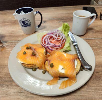 Smoked salmon and cream cheese on a toasted bagel with tomatoes, onions, and capers. Fresh and tasty!