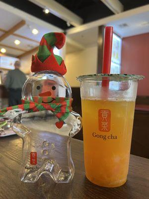 Mango green tea with mango popping pearls and star jelly, featuring a gingerbread bottle for the winter holidays