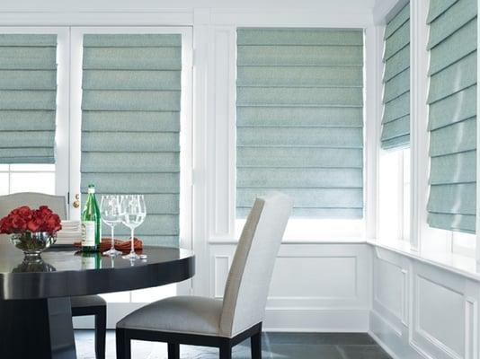 A very modern beachy look with light blue cordless roman shades in a soft fold.