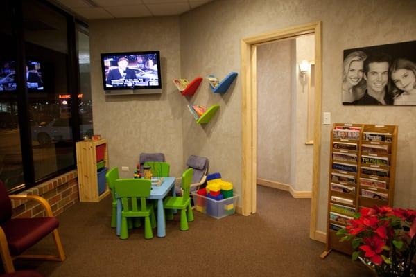 Kid's play area: Books, wooden building blocks, coloring books w/crayons, Legos, and puzzles.