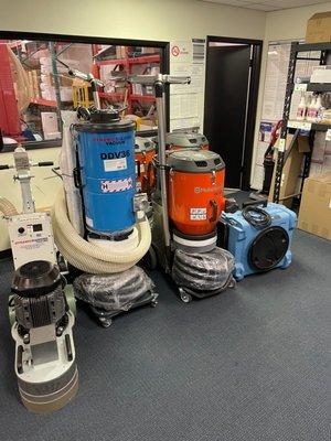 Row of concrete grinding and dust collecting equipment inside Jon-Don San Diego