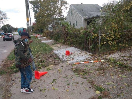 Middle progress of us cutting and removing those tall weeds. As you can see it allowed the city to safely fix the concrete.