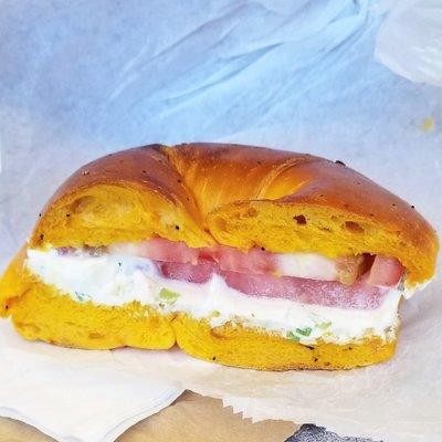 Egg bagel with scallion cream cheese and tomato