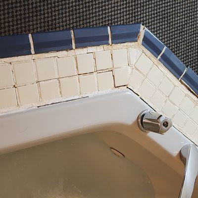 Lovely tile work around whirlpool tub.