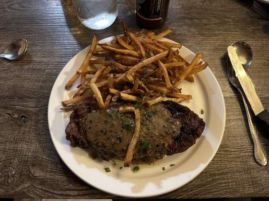 NY Steak with fries and peppercorn sauce.