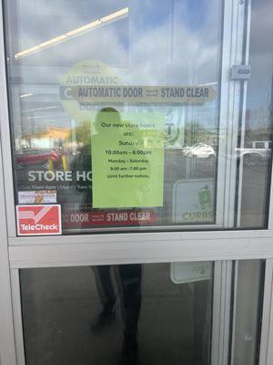 New store hours on entrance doors