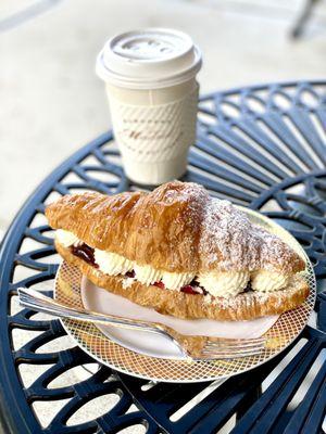 Croissant stuffed with whipped cream and strawberries