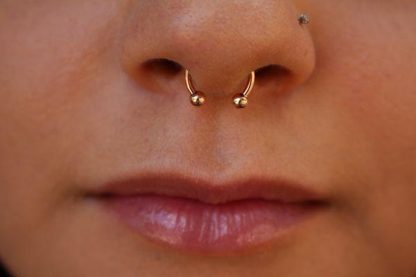 Fresh septum piercing with a rose gold circular barbell. Pierced by Aubrilynn!