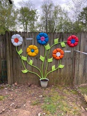 Party dip trays, garden hose, planter pot & garden soil, all from the dollar store.