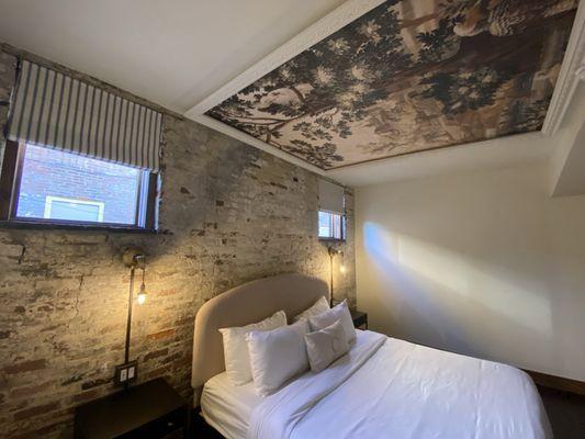 Bedroom area with ceiling tapestry