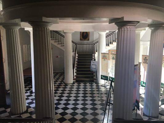 Looking across the entry from one staircase to another.