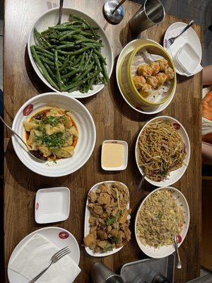 Green beans, shrimp and pork shumai, wontons in chili oil, vegetable chow mein, popcorn chicken, egg fried rice