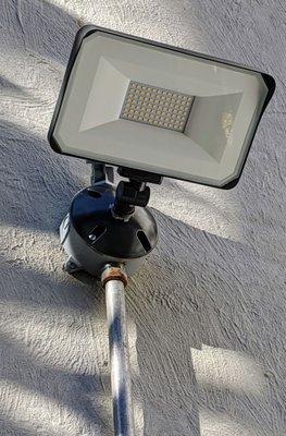 100 watt LED floodlight installed with photo cell. (Close-Up)