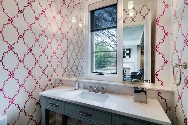 This powder room is stenciled with a raspberry colored design.  Notice how it is reflected in the mirror over the counter top.