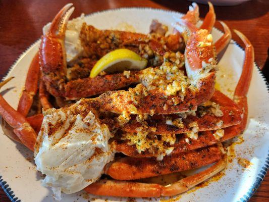 Garlic butter crab legs with crispy potatoes.