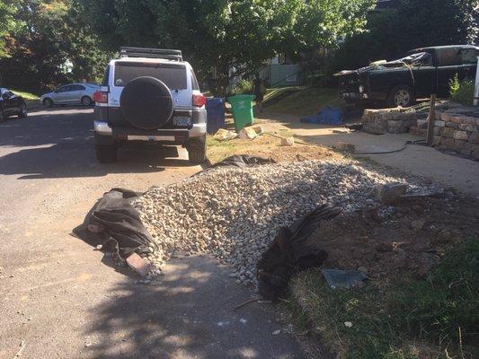 Our gravel was delivered on the street. The picture shows the gravel after my husband worked for an hour getting it off the street.