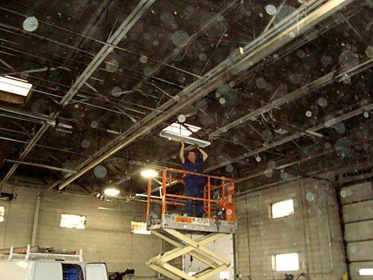 Mike installing high bay lights for machine shop.