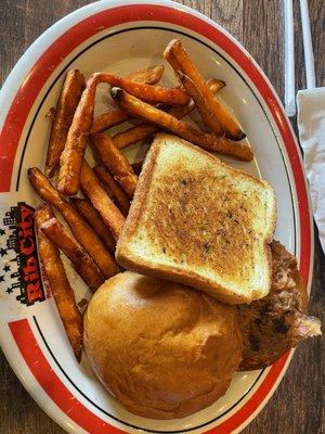 Pulled pork sandwich, sweet potato fries and garlic bread