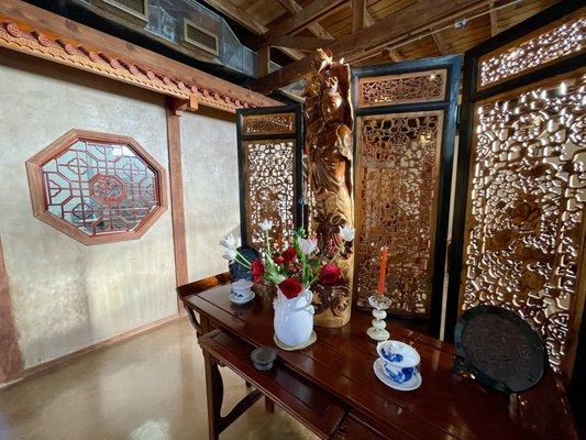 Interior of teahouse; Guanyin statue detail photo.