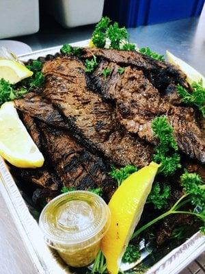 Freshly grilled Carne Asada served with Chimichurri and Lemon