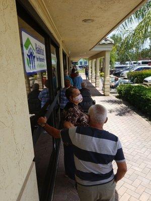 Line of people waiting for store to open currently  15 minutes late