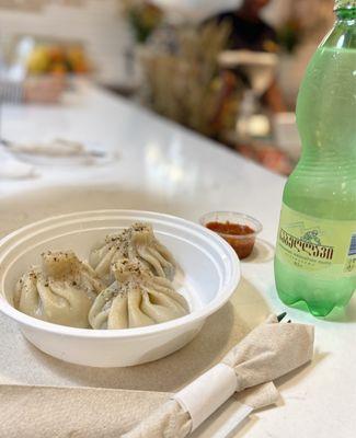 Mushroom khinkali, adjika, and mineral water.