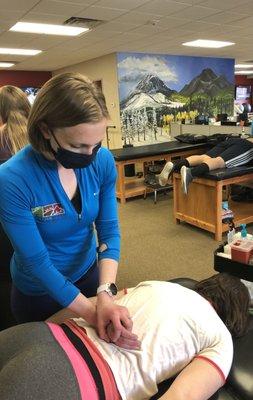 Justine Anderson PT, DPT, ITPT works on her patient's lower back that has been causing her discomfort.